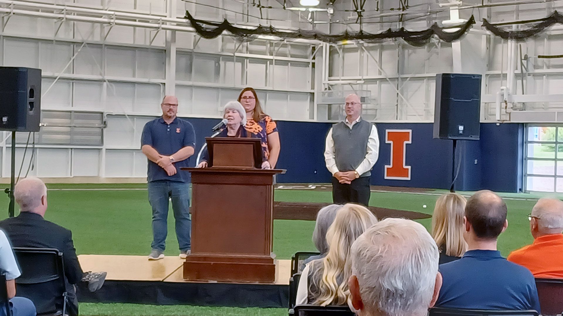 Susie Atkins speaking at the dedication of the Susan and Clint Atkins Baseball Training Center in 2022.